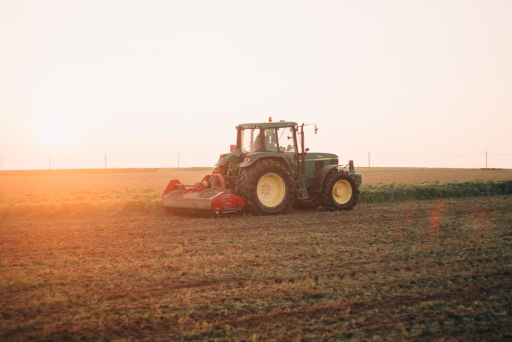red-tractor-on-brown-field-during-daytime-zty0rqgqb5g
